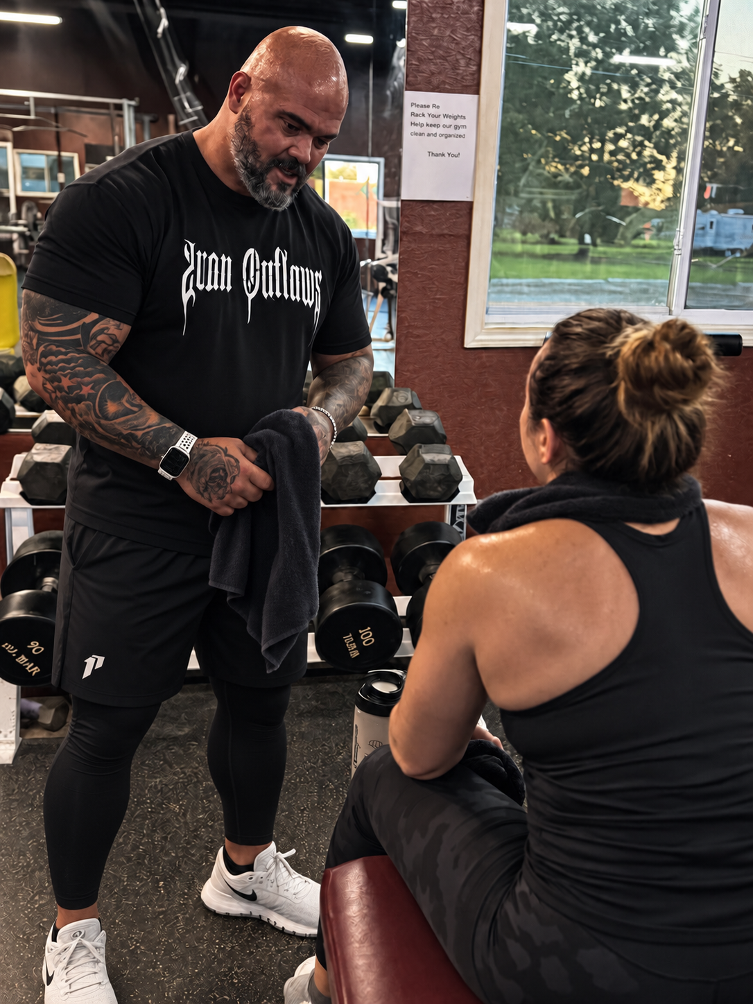 Eric coaching a gym exercise with a trainee